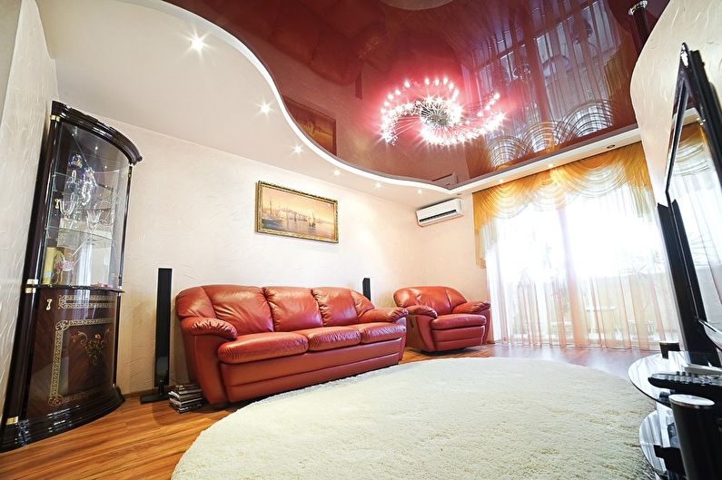 Red stretch ceiling in the hall (living room) - photo