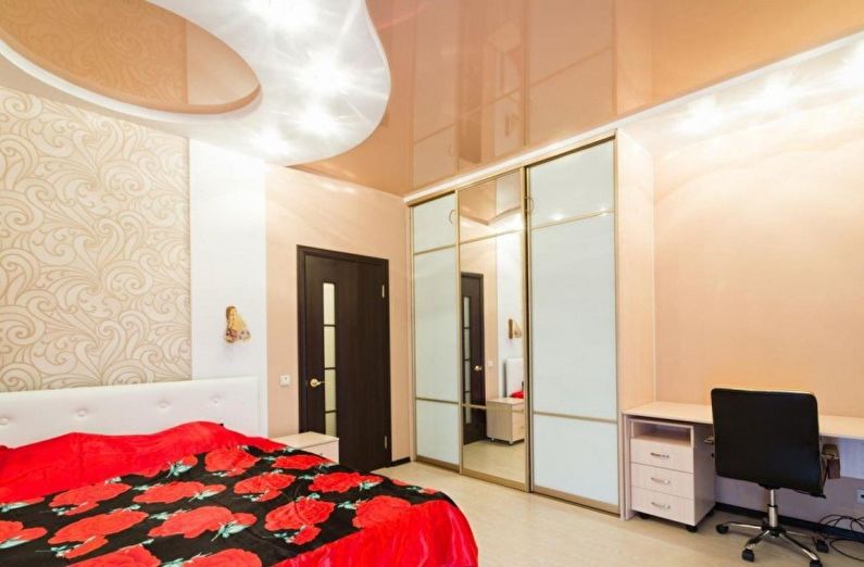 Beige stretch ceiling in the bedroom - photo