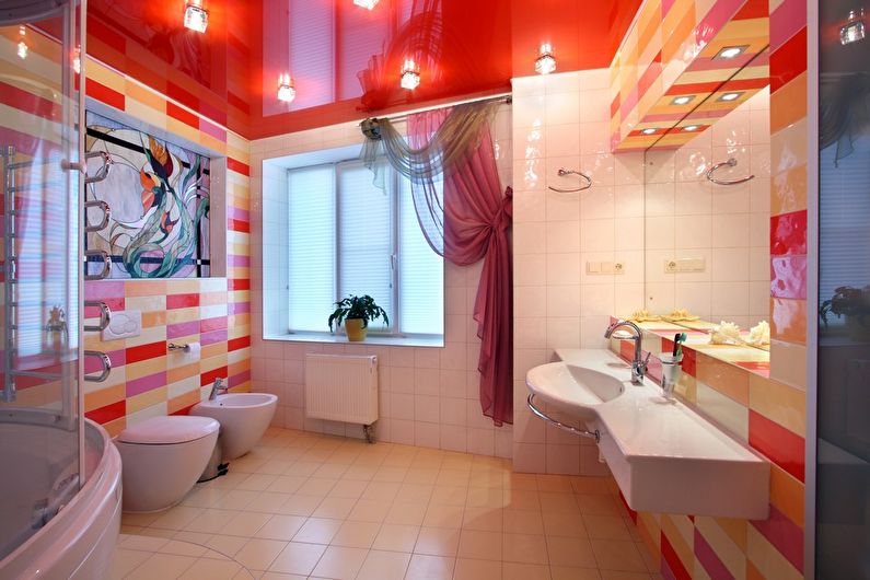 Red glossy stretch ceiling in the bathroom - photo