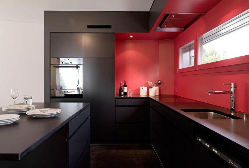 The combination of colors in the interior of the kitchen - black with red