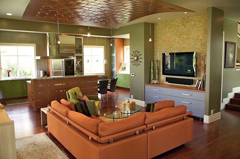 The combination of colors in the interior of the living room - orange with green and brown