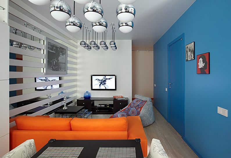 The combination of colors in the interior of the living room - blue with orange and white