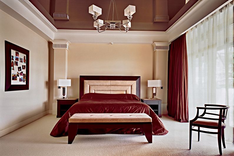 Brown glossy stretch ceiling in the bedroom - photo